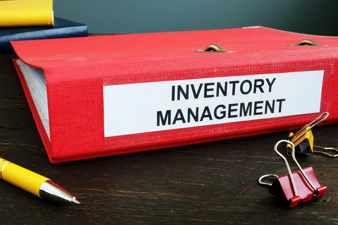 Folder with papers about Inventory Management and pen.