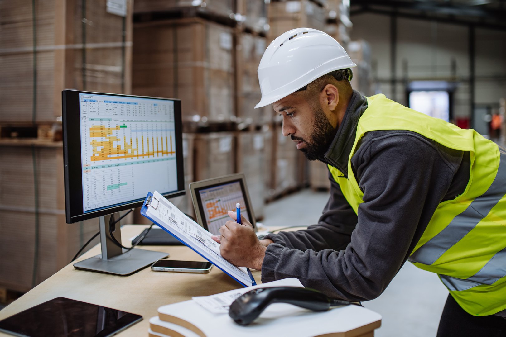 Warehouseman Checking Delivery, Stock in Warehouse on Computer, Pc. Warehouse Manager Using Warehouse Management Software, App.